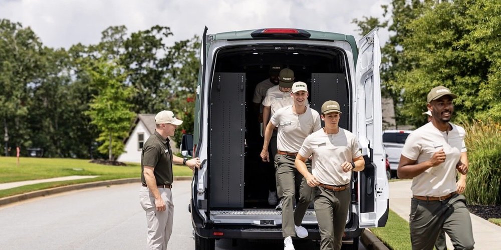 Acrew Home Professionals team running out of a service van